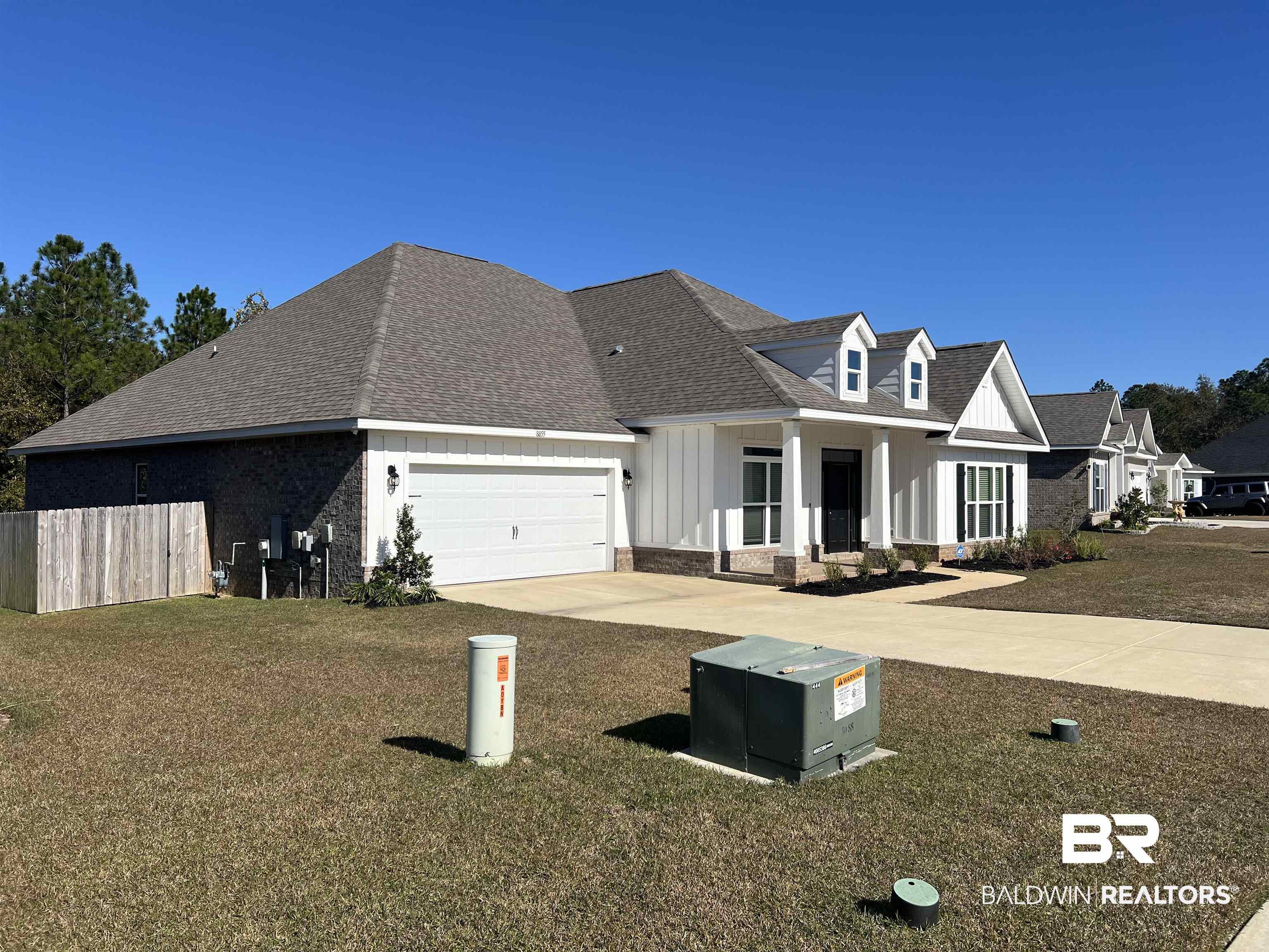 8855 Calverton Street Foley, AL 36535 - Photo 3 of 76 View of front of property with a garage and a front lawn