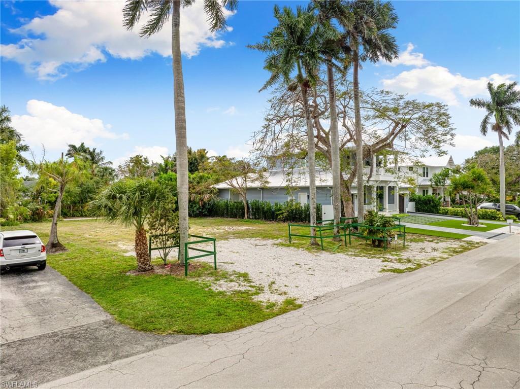 1084 Broad Avenue North Naples, FL 34102 - Photo 4 of 16 View of front facade featuring a front lawn