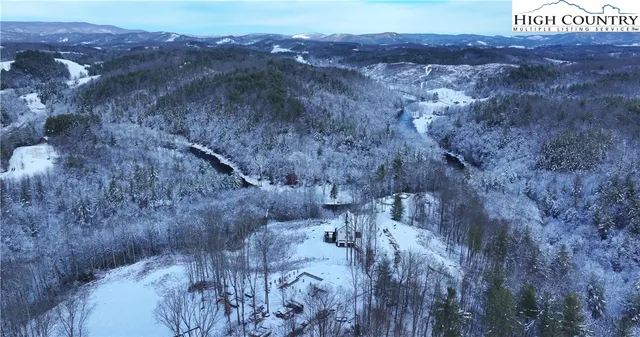 a view of a dry yard with mountains in the background