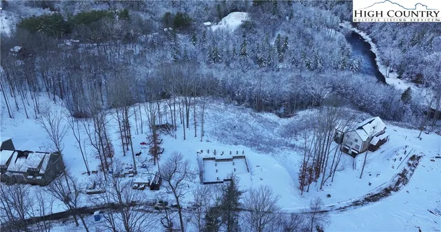 a view of dirt yard with a large tree
