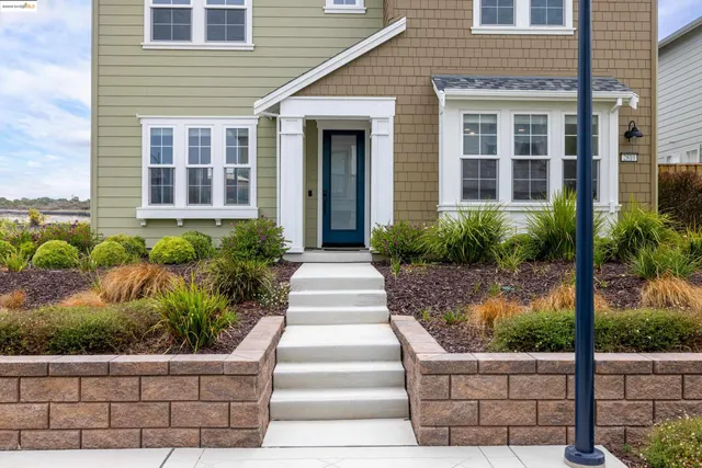 a front view of a house with plants and flowers