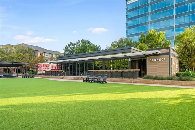 a view of a patio with a table chairs and a backyard