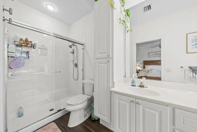 a bathroom with a sink a toilet and shower