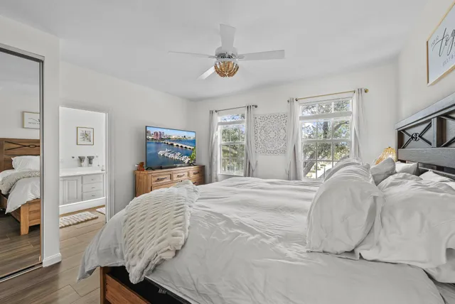 a bedroom with a bed and a flat screen tv