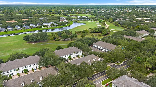 an aerial view of residential houses with outdoor space and street view