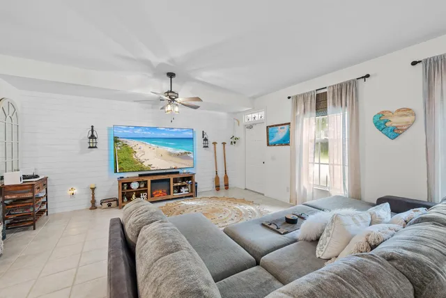 a living room with furniture a fireplace and a flat screen tv