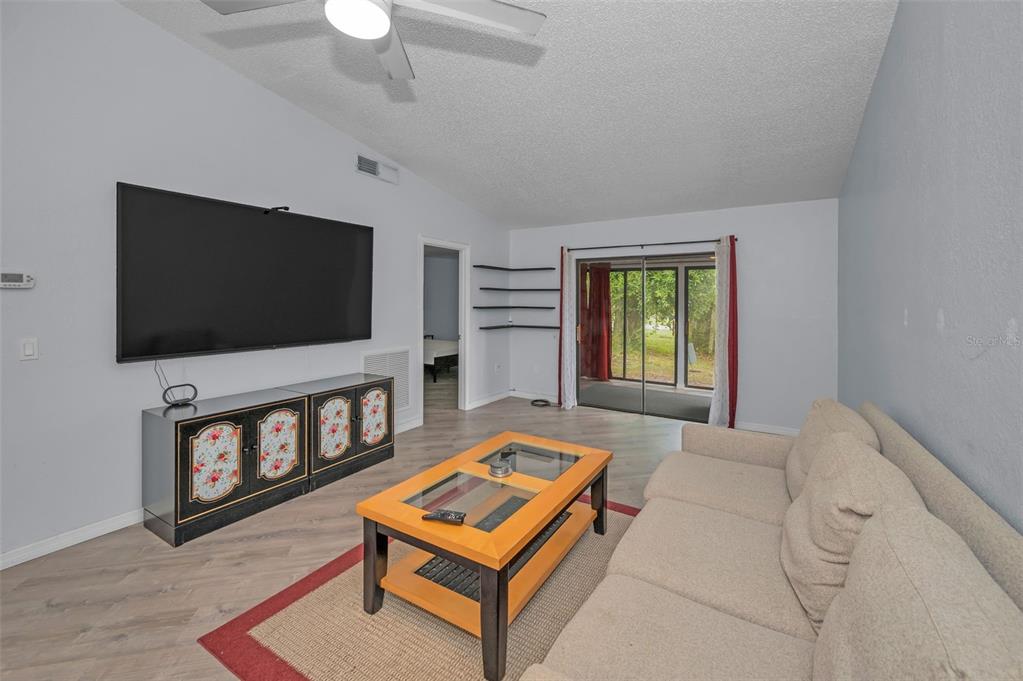 1890 Wolford Road, Unit 3 Clearwater, FL 33760 - Photo 12 of 47 a living room with furniture and a flat screen tv