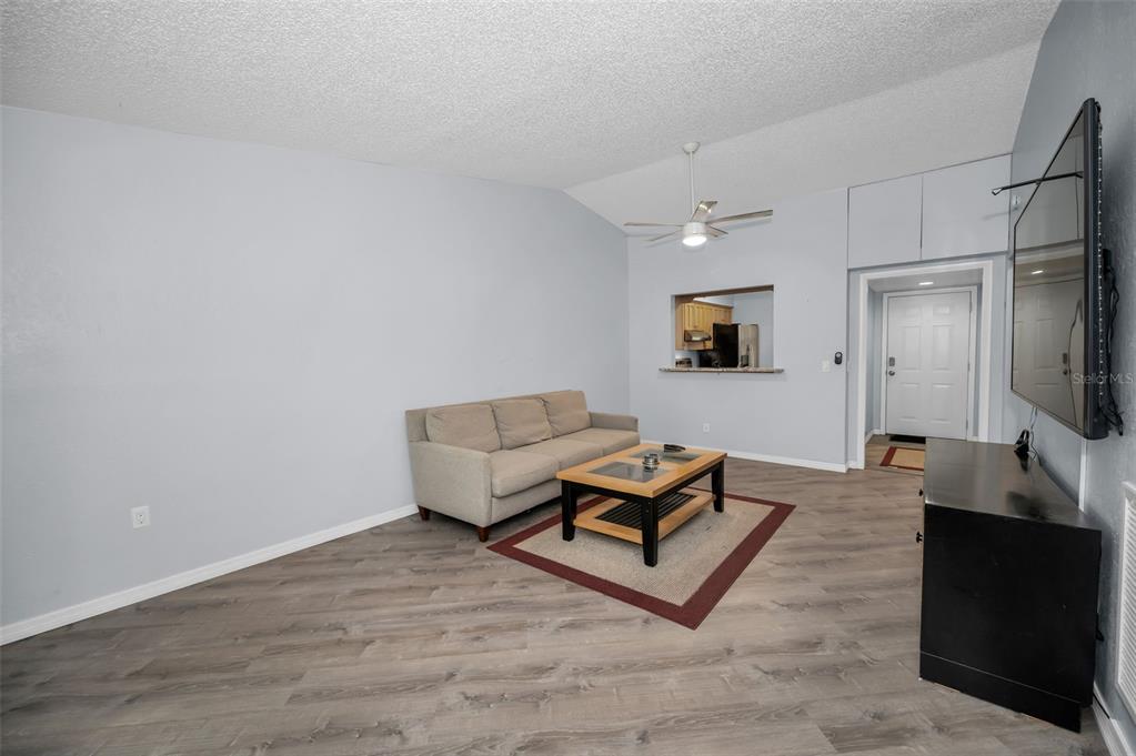 1890 Wolford Road, Unit 3 Clearwater, FL 33760 - Photo 15 of 47 a living room with furniture and a flat screen tv