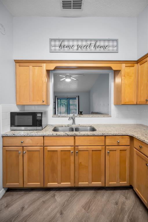 1890 Wolford Road, Unit 3 Clearwater, FL 33760 - Photo 18 of 47 a kitchen with a sink and a large window