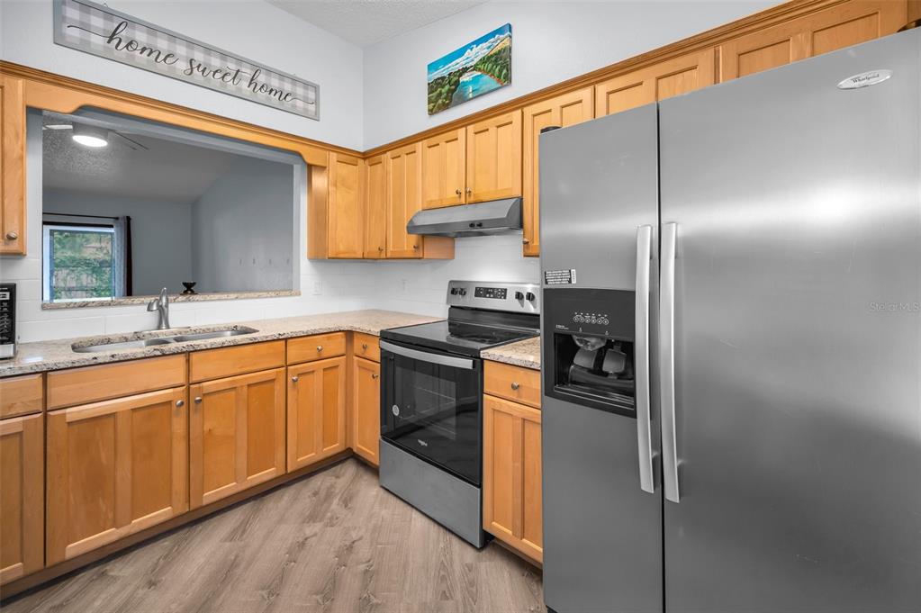 1890 Wolford Road, Unit 3 Clearwater, FL 33760 - Photo 19 of 47 a kitchen with stainless steel appliances granite countertop a refrigerator and a sink