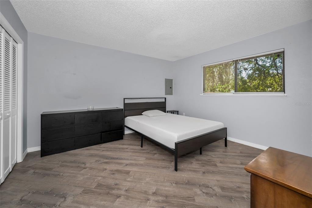 1890 Wolford Road, Unit 3 Clearwater, FL 33760 - Photo 22 of 47 a bedroom with a bed and a window