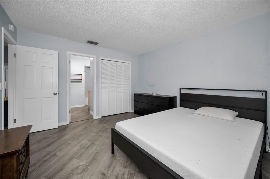 1890 Wolford Road, Unit 3 Clearwater, FL 33760 - Photo 23 of 47 a room with a bed and wooden floor