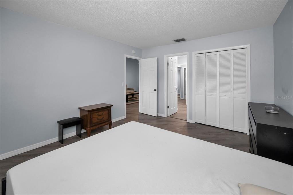 1890 Wolford Road, Unit 3 Clearwater, FL 33760 - Photo 24 of 47 a bedroom with a bed and a table