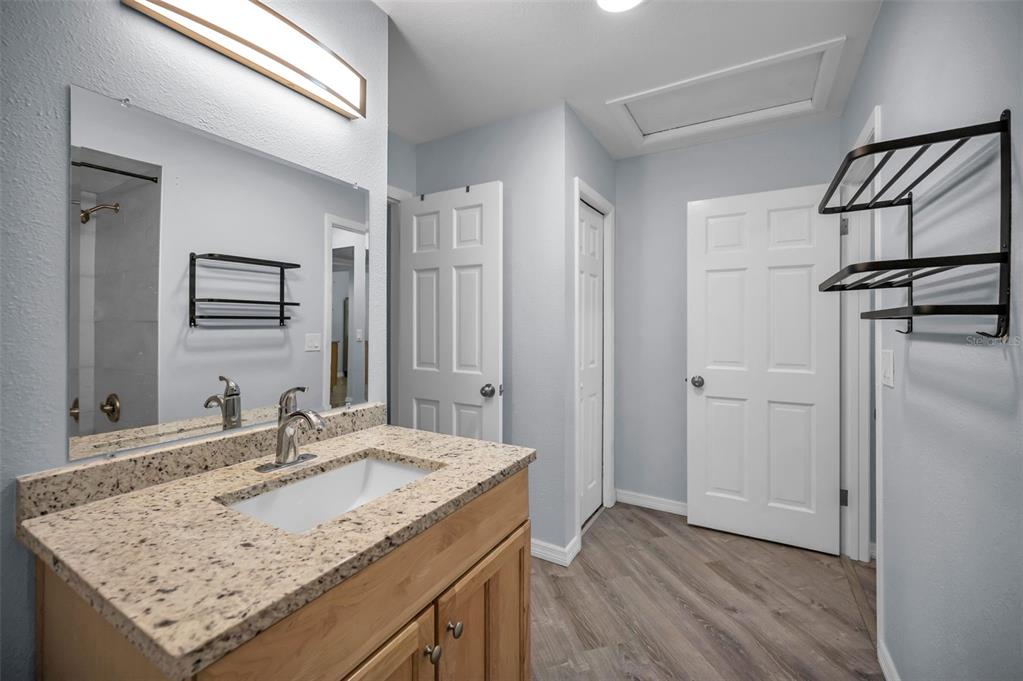 1890 Wolford Road, Unit 3 Clearwater, FL 33760 - Photo 28 of 47 a bathroom with a granite countertop sink and a mirror