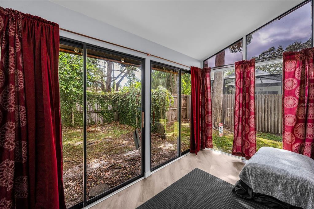 1890 Wolford Road, Unit 3 Clearwater, FL 33760 - Photo 32 of 47 a living room with a bed and a large window