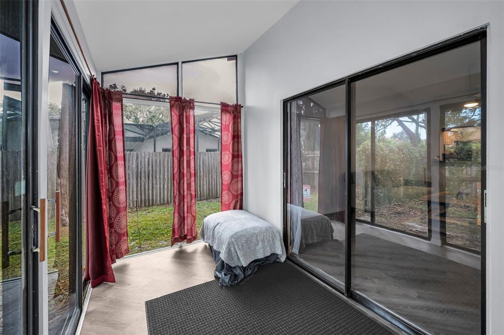 1890 Wolford Road, Unit 3 Clearwater, FL 33760 - Photo 34 of 47 a bedroom with a bed and a mirror