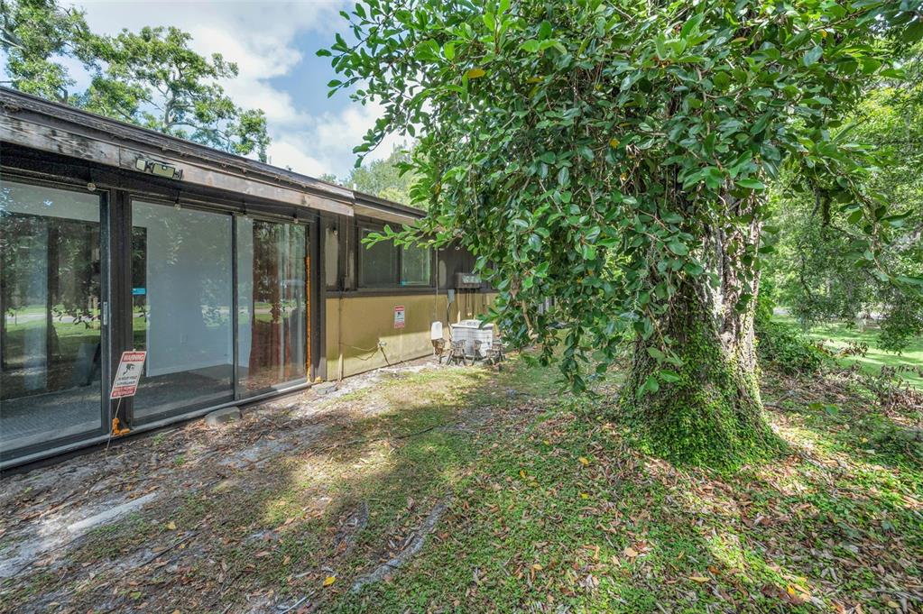 1890 Wolford Road, Unit 3 Clearwater, FL 33760 - Photo 40 of 47 a view of a chair and table in the backyard of the house