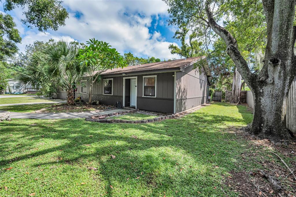 1890 Wolford Road, Unit 3 Clearwater, FL 33760 - Photo 4 of 47 a view of a house with yard and a tree