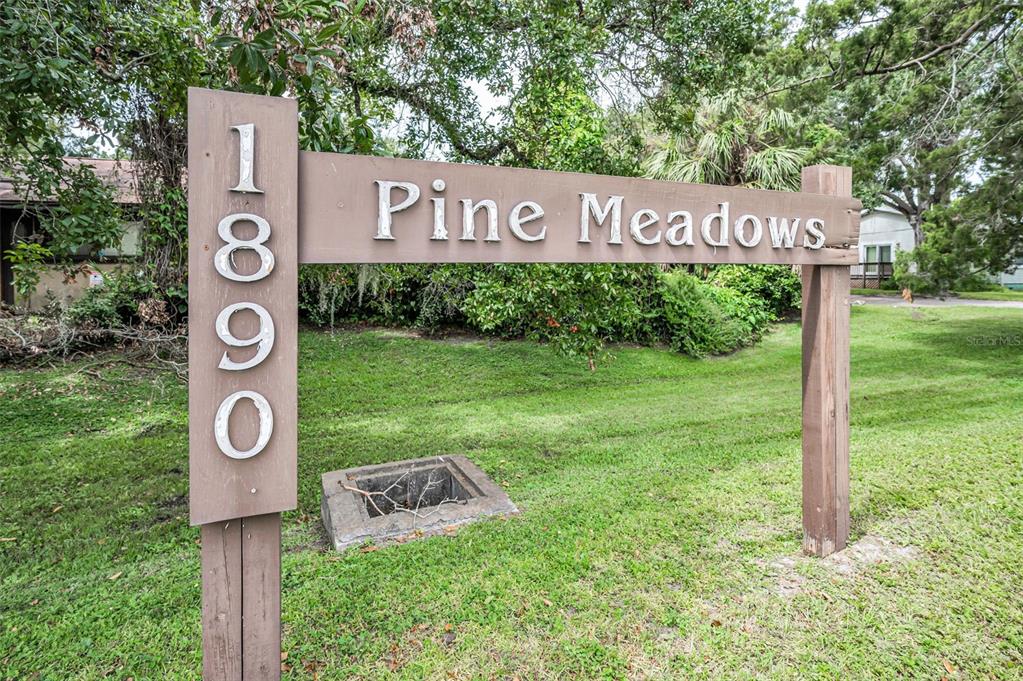 1890 Wolford Road, Unit 3 Clearwater, FL 33760 - Photo 47 of 47 a street sign that is sitting on a wooden wall