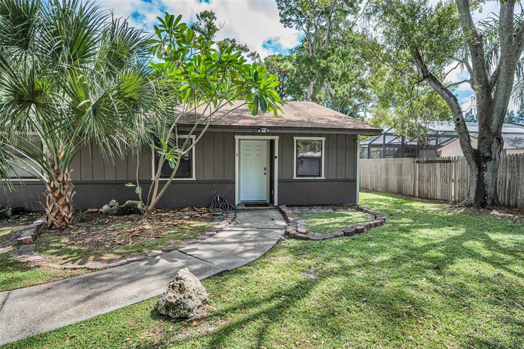 1890 Wolford Road, Unit 3 Clearwater, FL 33760 - Photo 5 of 47 a house with trees in front of it