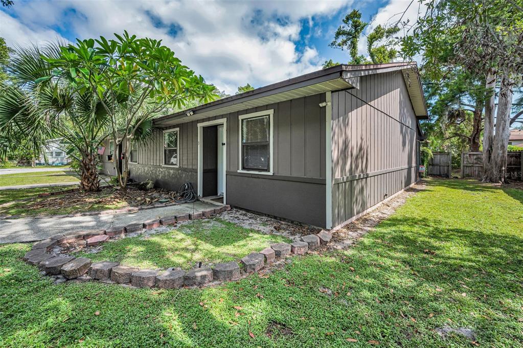 1890 Wolford Road, Unit 3 Clearwater, FL 33760 - Photo 6 of 47 a view of backyard with small cabin and wooden fence