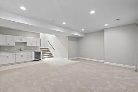 a view of an empty room with a kitchen