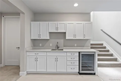 a kitchen with cabinets appliances and a sink