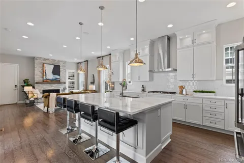 a large kitchen with kitchen island a sink table and chairs