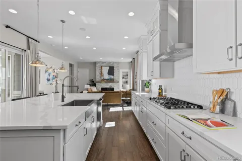 a large kitchen with stainless steel appliances lots of counter space and wooden floor