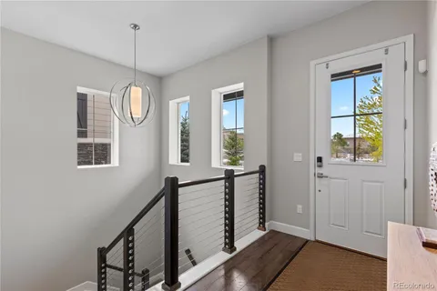 a view of an entryway with wooden floor and windows