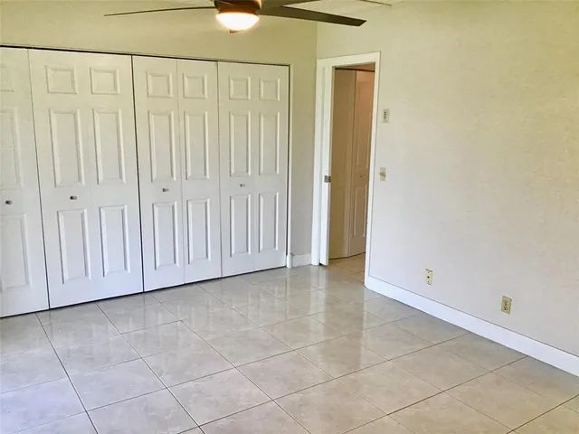 a view of a livingroom with an empty space and a window