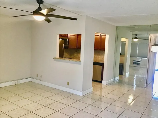 a kitchen with granite countertop cabinets and steel stainless steel appliances with wooden floors
