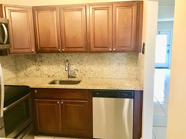 a view of a bathroom with a sink and a mirror
