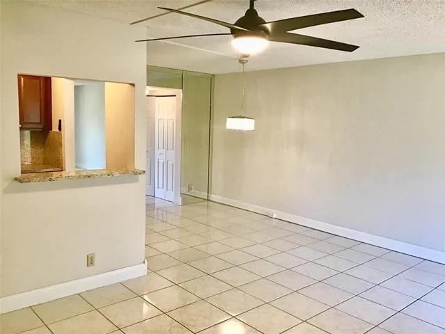 a kitchen with a refrigerator and microwave