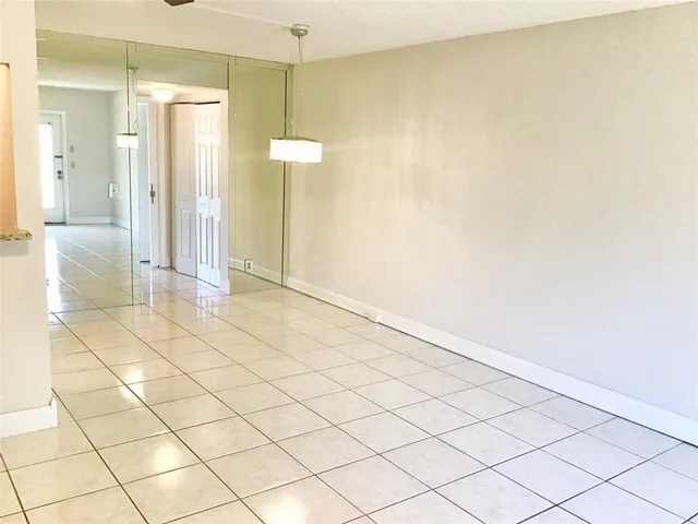 a view of a livingroom with an empty space and a window