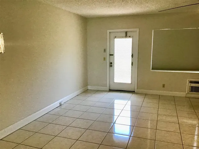 a view of a livingroom with an empty space and a window