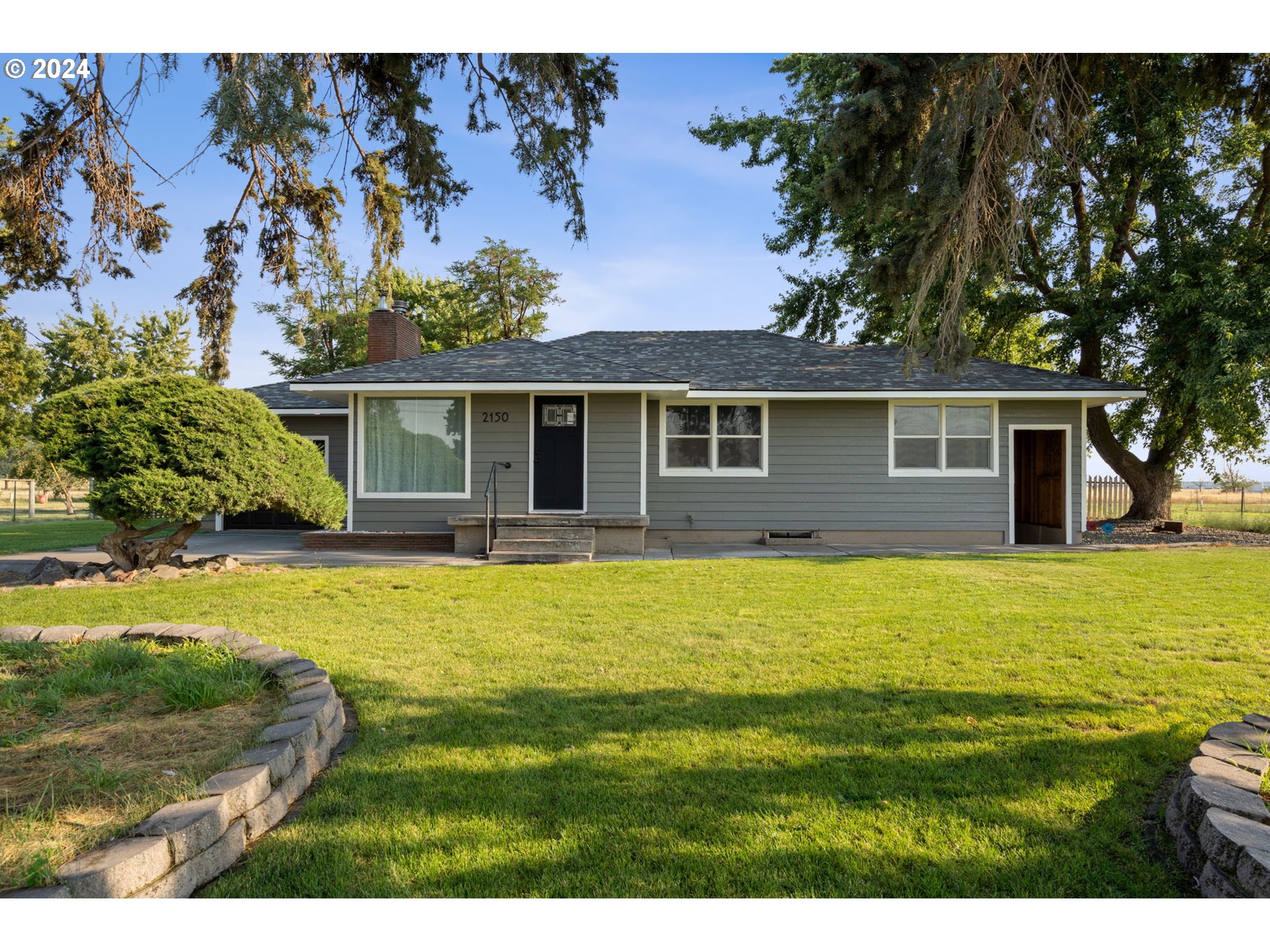 2150 East Airport Road Hermiston, OR 97838 - Photo 1 of 37 a front view of a house with a yard