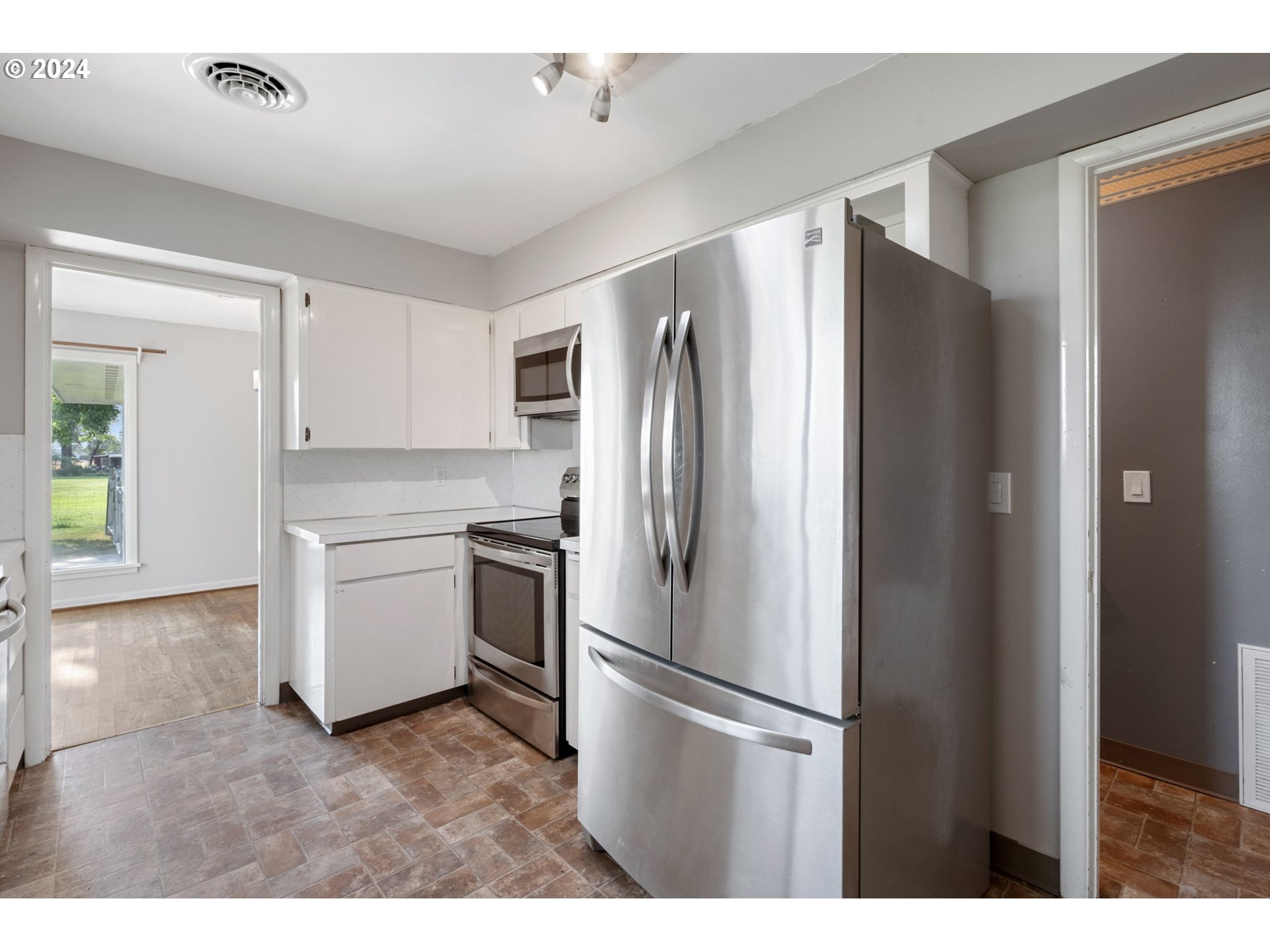 2150 East Airport Road Hermiston, OR 97838 - Photo 11 of 37 a white refrigerator freezer sitting in a kitchen
