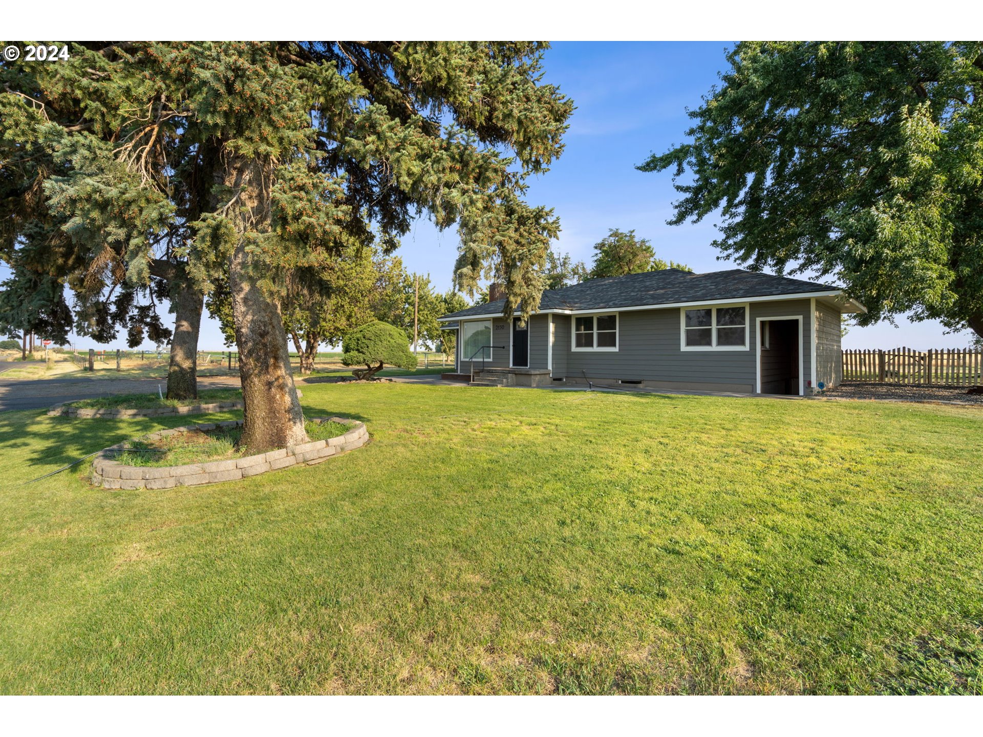 2150 East Airport Road Hermiston, OR 97838 - Photo 2 of 37 a view of a house with yard and sitting area