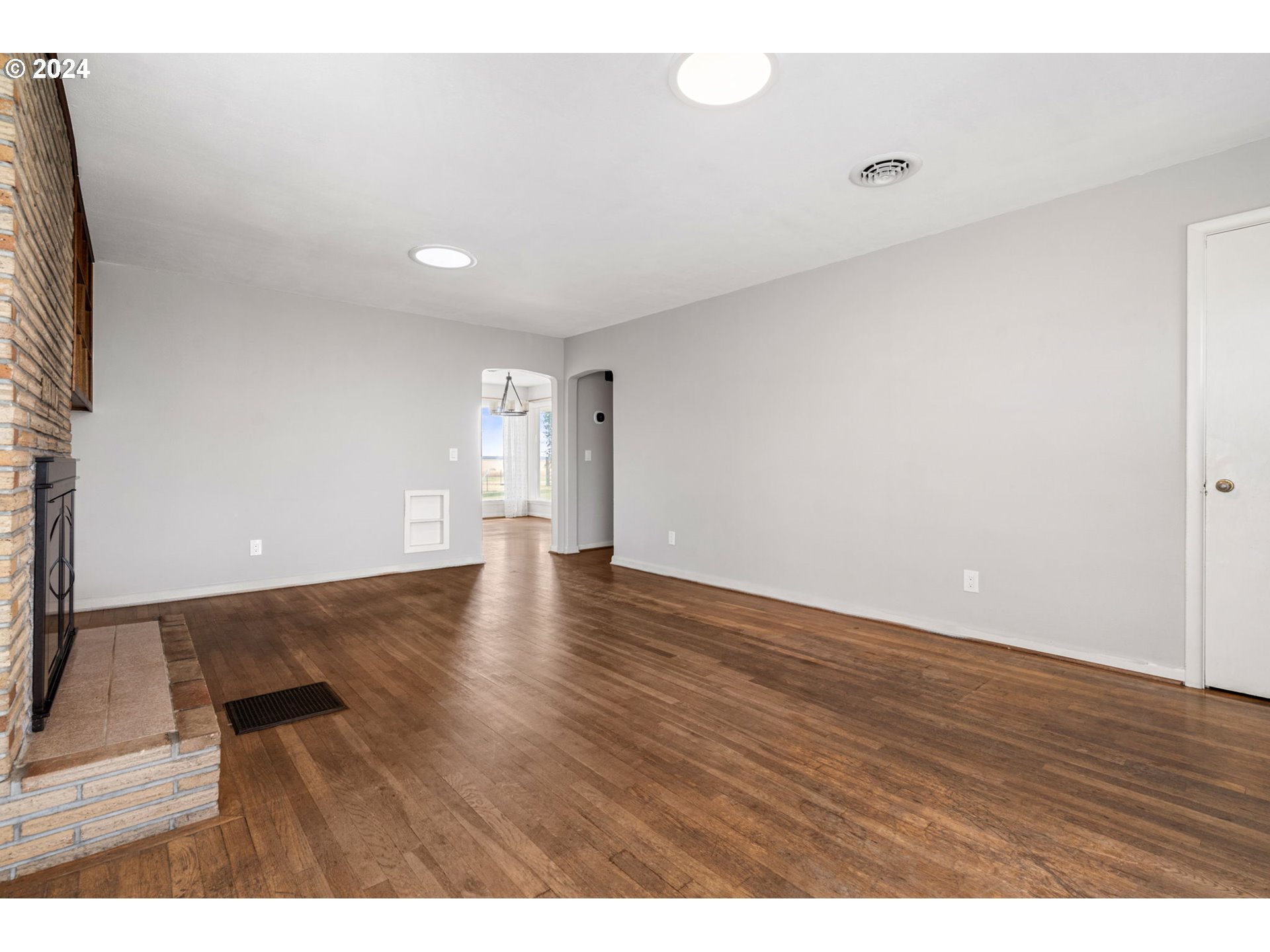 2150 East Airport Road Hermiston, OR 97838 - Photo 5 of 37 a view of an empty room with wooden floor and a window