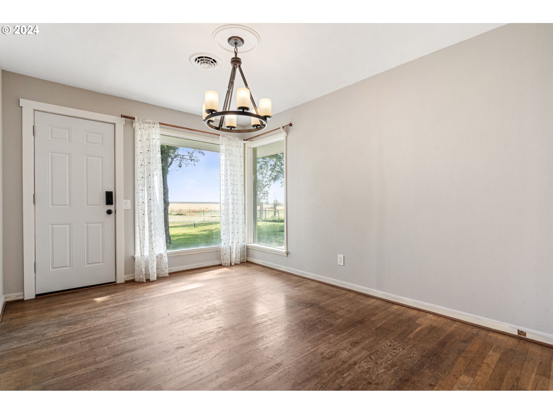 2150 East Airport Road Hermiston, OR 97838 - Photo 8 of 37 a view of empty room with wooden floor and fan