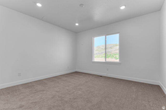 1341 West 2350 South, Unit 10 Perry, UT 84302 - Photo 10 of 18 Carpeted room featuring a white-framed window, recessed ceiling lights, white walls, and white baseboards