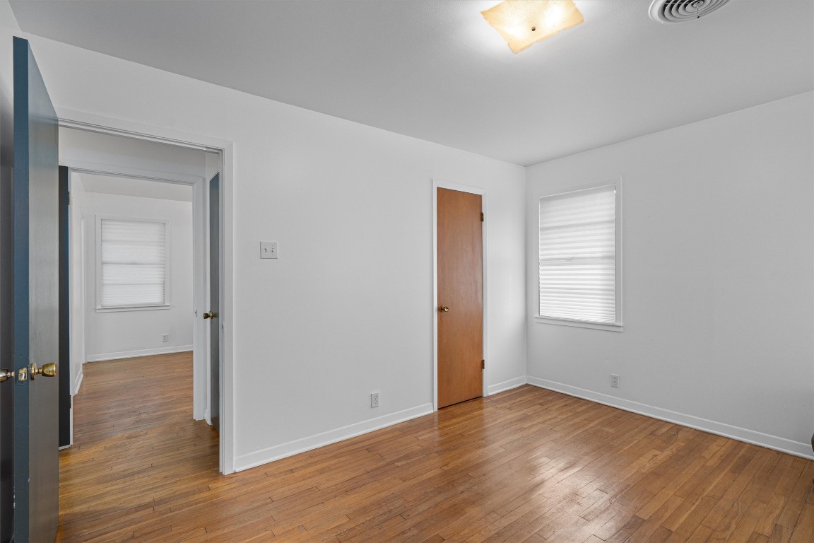 Undisclosed Address Temple, TX 76504 - Photo 13 of 18 a view of an empty room with wooden floor and a window