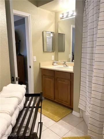 a en suite bathroom with a double vanity sink a mirror and a shower