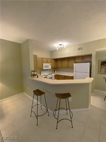 a room with table chairs and window