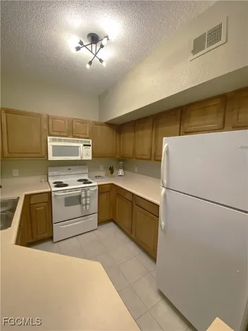 a kitchen with a refrigerator and a sink