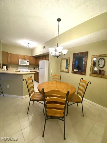 a view of a dining room with furniture and chandelier
