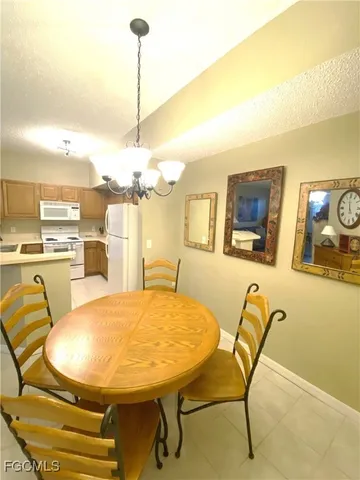 a view of a dining room with furniture and a chandelier