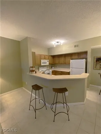 a room with table chairs and window