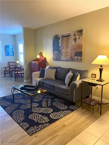 a living room with furniture and a dining table